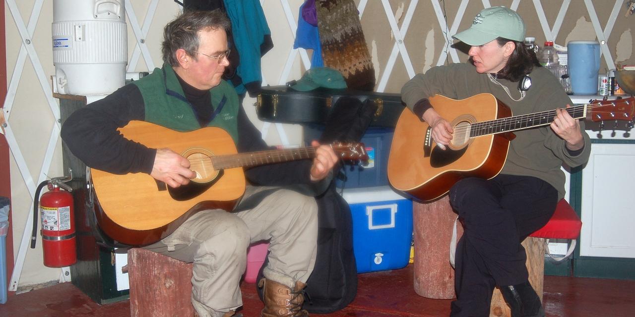 Bruce and Amy playing guitar at the Skier's Camp